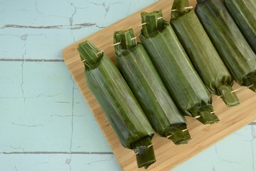 Lemper Ayam, Indonesian snack made of glutinous rice filled with seasoned shredded chicken wrapped in banana leaf