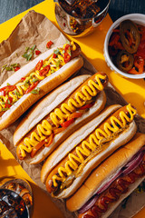 American hot dog with ingredients on a dark wooden background