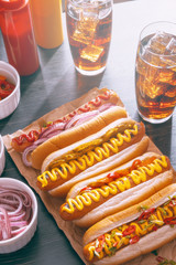 American hot dog with ingredients on a dark wooden background