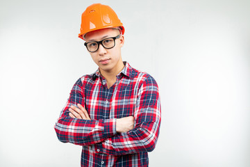 man in glasses an orange helmet of the builder on a white background
