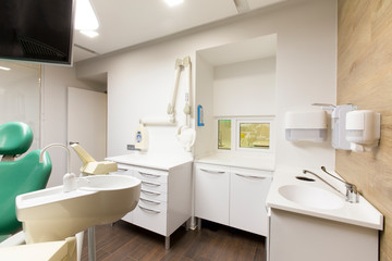Fototapeta na wymiar Sink, soap and sanitizer for dentist in modern hospital room