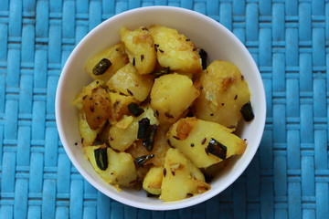 Aloo jeera fry or potato cumin fry, Indian food made with boiled potatoes turmeric, cumin, coriander leaves and green chilli