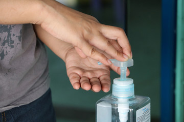 Hands is pressing the pump dispenser from pump bottle of alcohol gel or sanitizer gel for wash the hand, for killing germs and coronavirus.