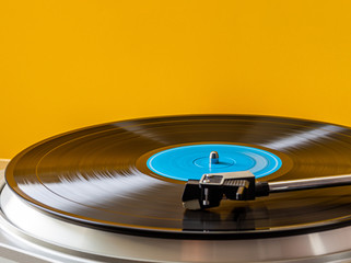 spinning vinyl record on a yellow background