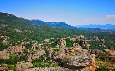 Fototapeta na wymiar Scenic Bulgarian landscape with mountains and forests as seen from the Belogradchick Rocks, amazing view in the landmark rock formations of Bulgaria