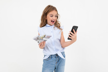 happy teenager girl holding money on a white background with copy space