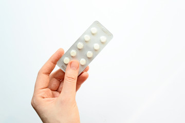 Cropped image of man taking pill out from blister pack at home