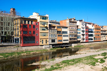 Colorful yellow, red and orange houses on river Onyar, Girona, Spain