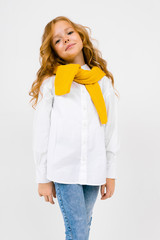 teenager model girl in a white shirt and jeans with a scarf and hat on a white isolated background