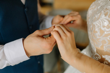 The groom holds the bride by the hands. Close-up. Wedding concept. Happy newlywed couple.