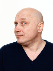 Fototapeta premium Portrait of a bald cheerful man on a white background