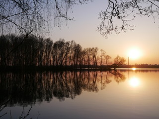 Fototapeta na wymiar Lake at sunset, on a background of trees. Reflection of nature in the lake. Diamond Lake Kiev, Ukraine.