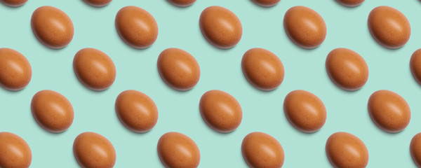 Seamless pattern of chicken eggs on green background. Food texture