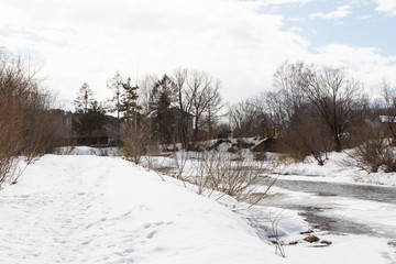 Fototapeta premium Winter rural river snowy landscape. Forest river in winter snow. Winter Forrest River Peisash