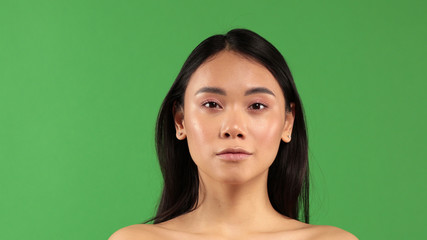 Fototapeta premium Closeup face of young asian woman exterior with clear skin on isolated background