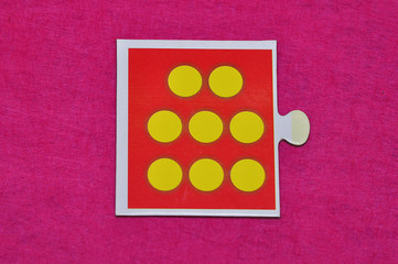 A jigsaw piece with eight dots