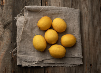yellow round lemons on a gray textile napkin