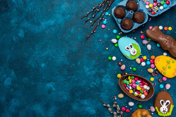 Colorful Easter Festive Background. Sweet Food Candy and Chocolate Eggs and Rabbit