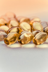 Cod liver oil capsules in a fish shape with copy space. Healthcare concept