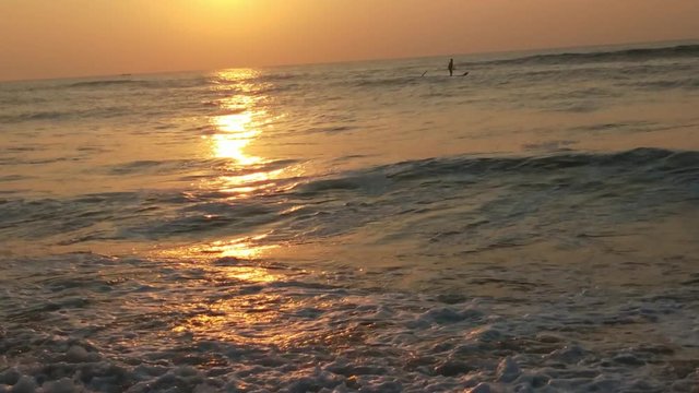 4K Sunrise over tropical island beach and palm trees. Phuket beach sea, View of beach sea on sun light in the summer. Colorful sunset over the beach in the tropical beach sea,the tropical paradise bea