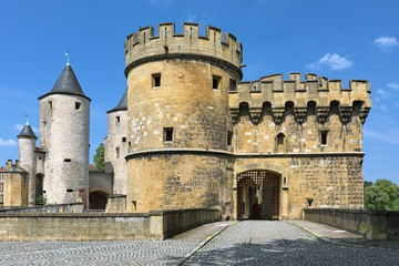 Fototapeta na wymiar Germans' Gate (Porte des Allemands) in Metz, France. This is the medieval fortified bridge with two round towers of the 13th century and two gun bastions of the 15th century.
