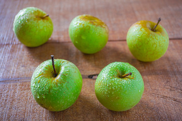 Natural fresh green apple or apel hijau. Healty fruit with contains many nutrients that are good for the body. on wooden background