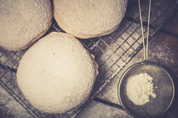 Traditional Polish donuts on wooden background. Tasty doughnuts with jam