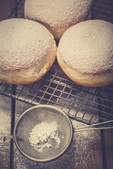 Traditional Polish donuts on wooden background. Tasty doughnuts with jam