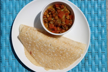 Ghavne or Ghavan or Amboli Neer dosa spongy, thin, fluffy and lacy crepes made with ground rice batter, authentic Maharashtrian dish, Indian traditional food served with curry 