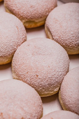 Traditional Polish donuts on wooden background. Tasty doughnuts with jam
