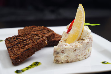 Salad with mayonnaise, grilled dark bread.
