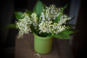  Bouquet of white lilies of the valley in a vase.