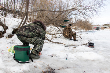 Winter fishing. Ice fishing. Fish in the snow, fishing rods for the winter and fisherman equipment....