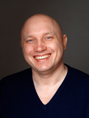 Obraz premium Portrait of a bald cheerful man on a black background