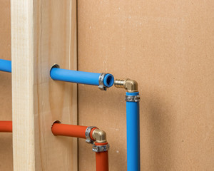 Pex plastic water supply plumbing pipe in wall of house. Concept of home repair, maintenance and remodeling