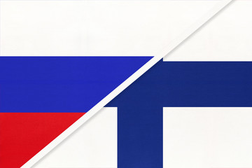 Russia vs Finland national flag from textile. Relationship and partnership between two countries.