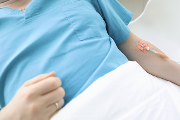 In sickman on hospital bed in his hand dropper. Complete set medical procedures prescribed by your doctor. Sterility drugs for injection into vein. Overdose threatens to develop complications