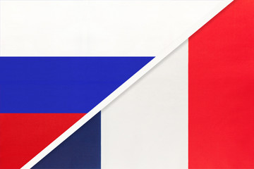 Russia vs France national flag from textile. Relationship and partnership between two countries.