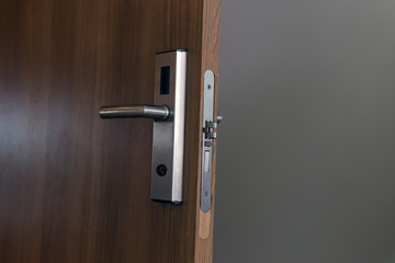 Wooden door with electronic lock. Close up view. 