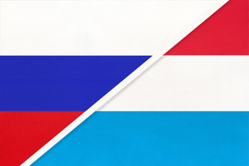 Russia vs Luxembourg national flag from textile. Relationship and partnership between two countries.