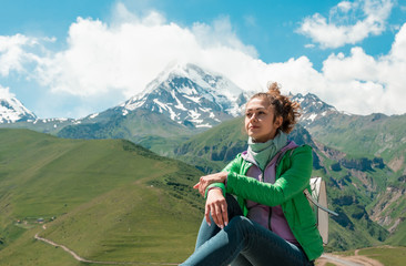 Pretty girl female on peak mountain with perfect view.