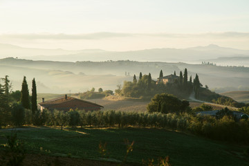 Fototapeta na wymiar Tuscany. Villa Belvedere at early foggy morning in Val d'Orcia, Italy