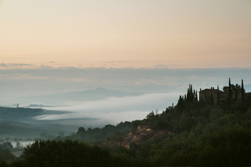Foggy valley in the Tuscany, Val d Orcia, Italy