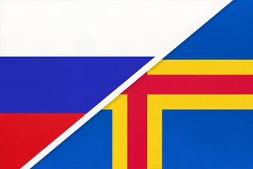 Russia vs Aland Islands national flag from textile. Relationship and partnership between two countries.