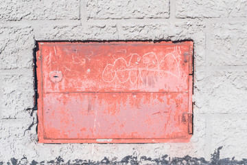 red hatch in a gray concrete wall