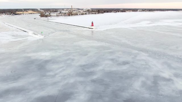 Icy winter flyby, Menominee North Pier Lighthouse. This lighthouse watches over the mouth of the Menominee River running between Marinette Wisconsin and Menominee Michigan.