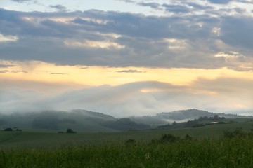 Fototapeta premium Sunrise or sunset over the hills and meadow. Slovakia