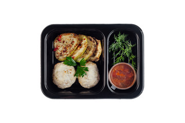 Healthy lunch at workplace. Take away meals in black containers with cutlery on gray table