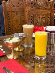 Traditional Indian food. Indian masala tea with coconut milk and Mango Lassi, yogurt or smoothie. Indian popular summer drink. Desserts and drinks in Indian restaurant in Kiev, Ukraine. Soft focus
