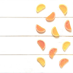 Multicolored fruit marmalade rests on a white wooden background